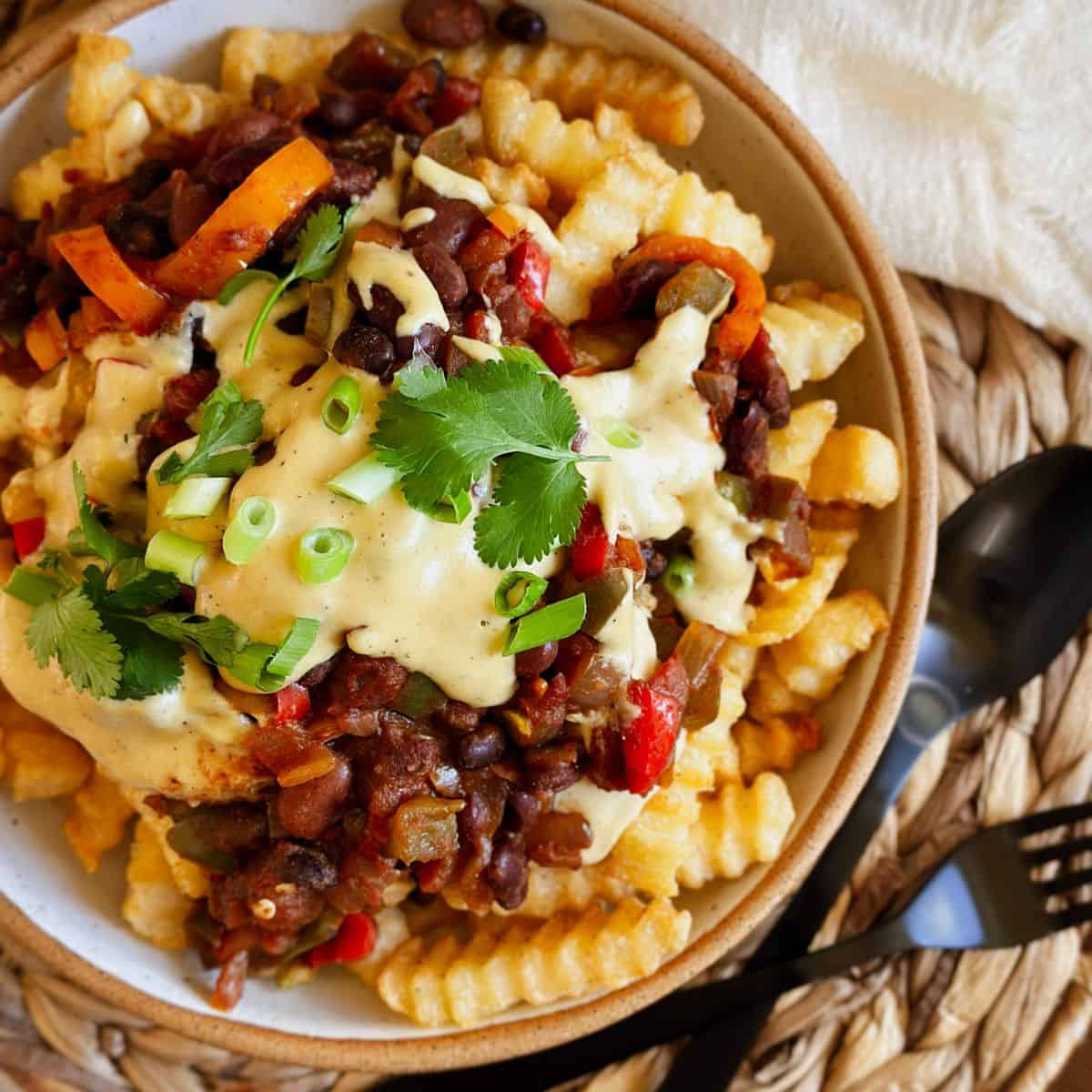 vegan chili cheese fries on a plate.