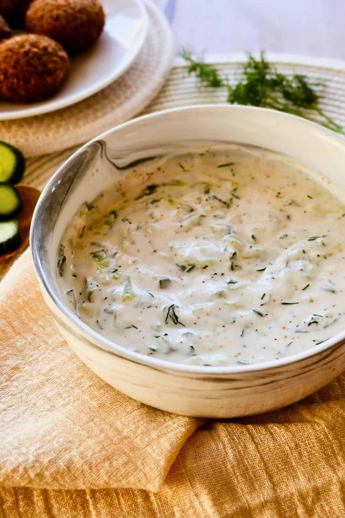Tzatziki sauce with veggies and falafel vegan tzatziki in a bowl.