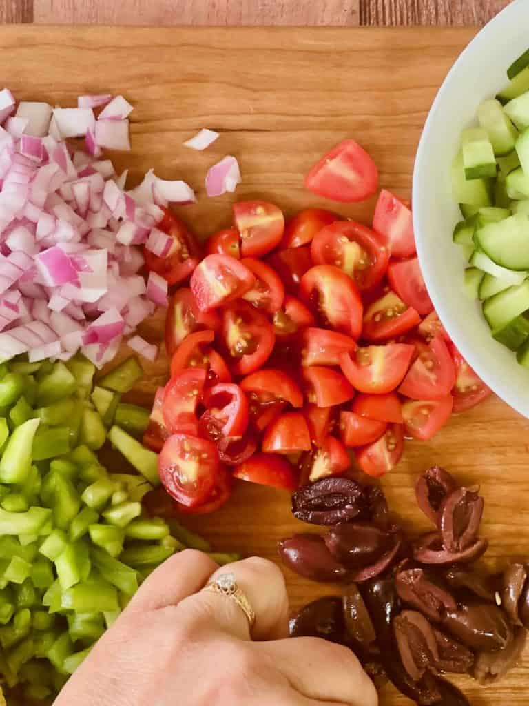 Cutting all the vegetables for vegan Greek salad