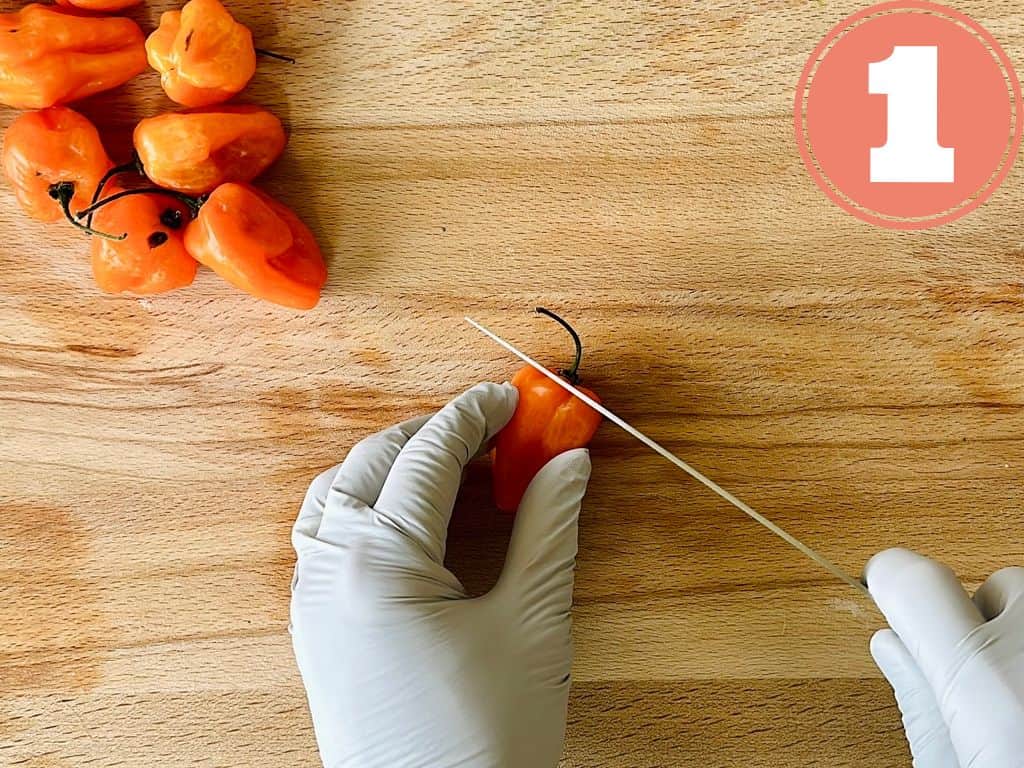 step 1 how to cut an habanero; slicing off the top while wearing gloves