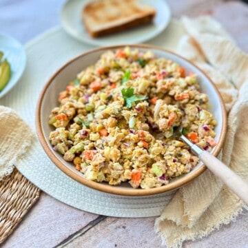 vegan chickpea tuna salad in a bowl with a spoon.