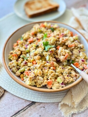 vegan chickpea tuna salad in a bowl with a spoon.