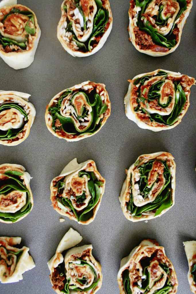 pizza rolls on a baking dish before baking; top view