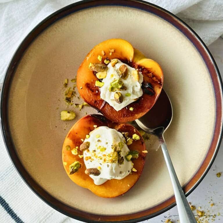 Grilled Peaches with vegan Mascarpone on a plate top view