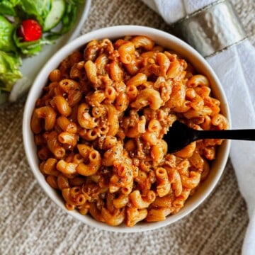 top view of Vegan Hamburger helper in a bowl with a fork picking some up.