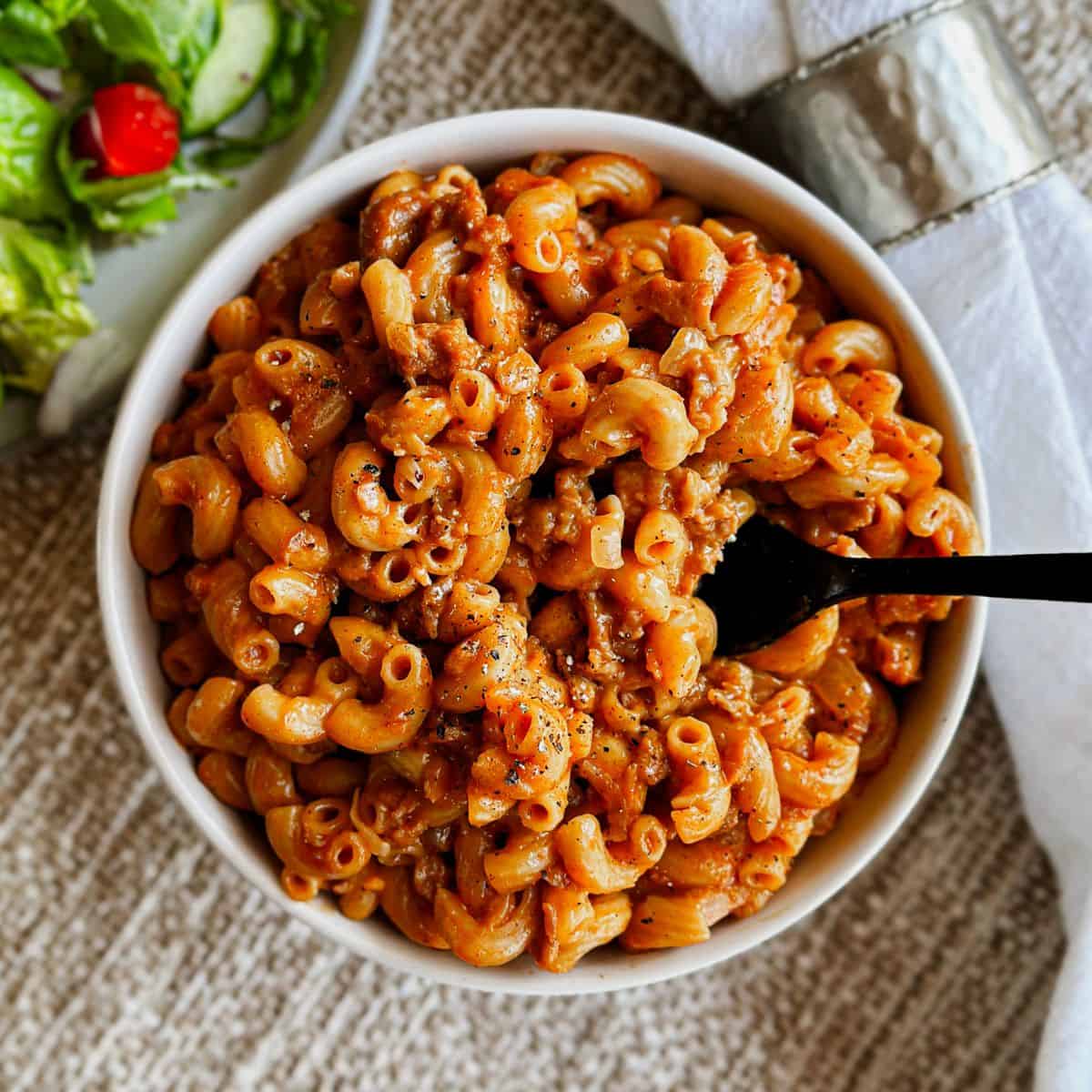 top view of Vegan Hamburger helper in a bowl with a fork picking some up.