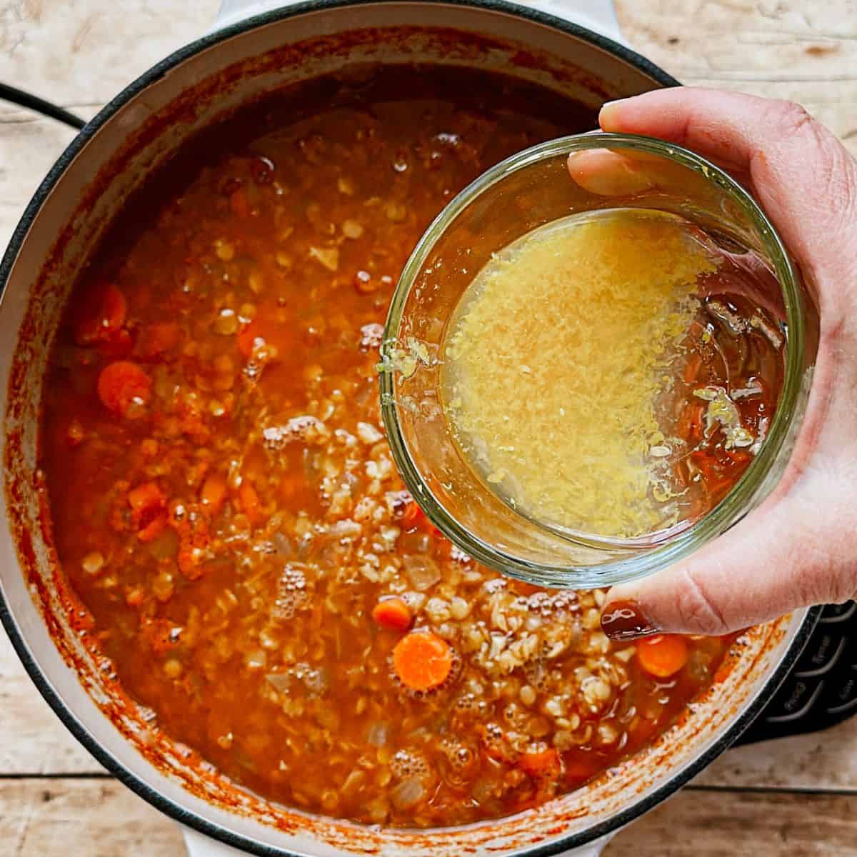 adding lemon zest and juice to healthy vegan red lentil soup