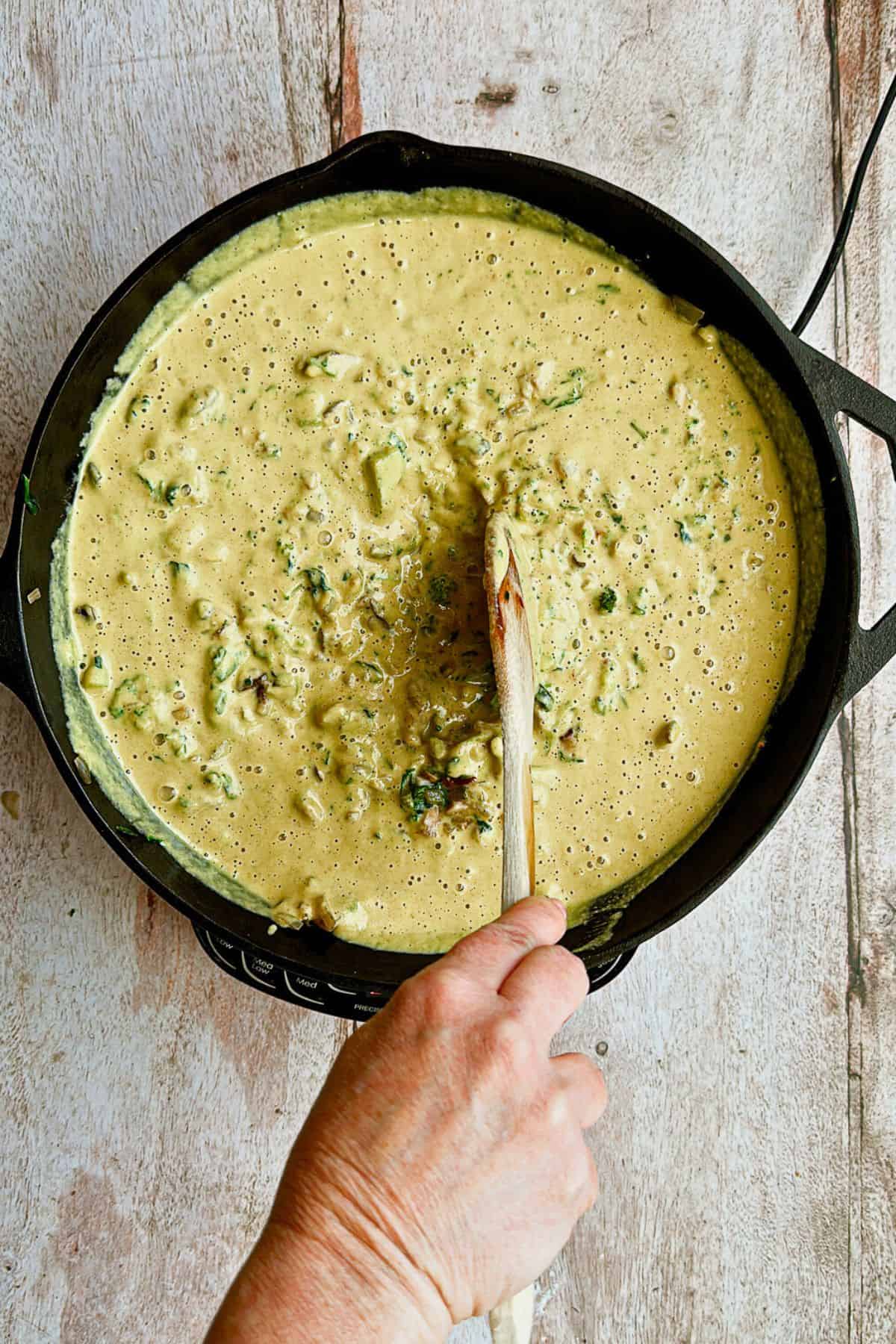 adding quiche mixture to sauteed vegetables