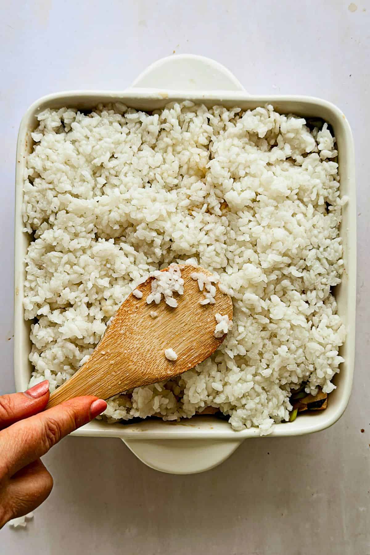 top view adding second layer of rice to the vegan sushi bake casserole