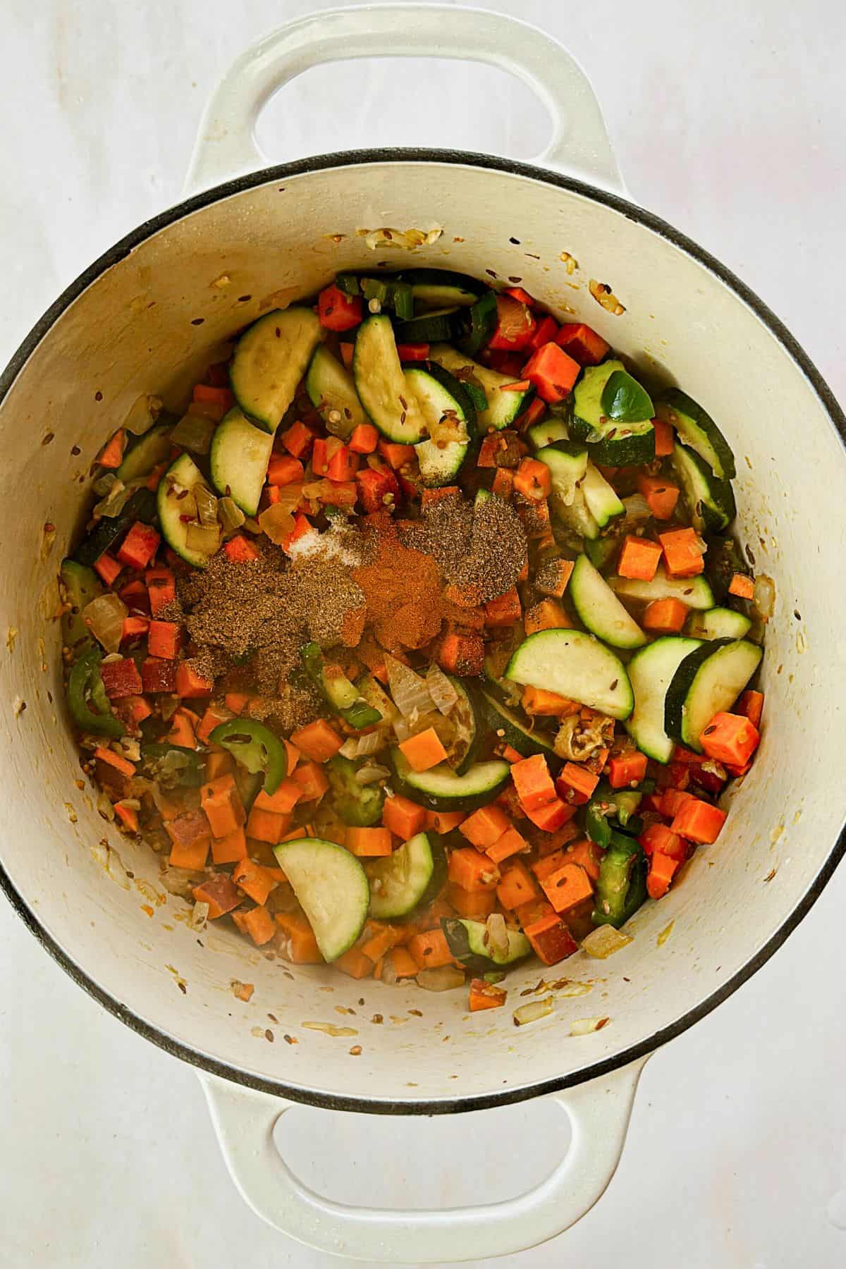 adding spices to split mung bean curry