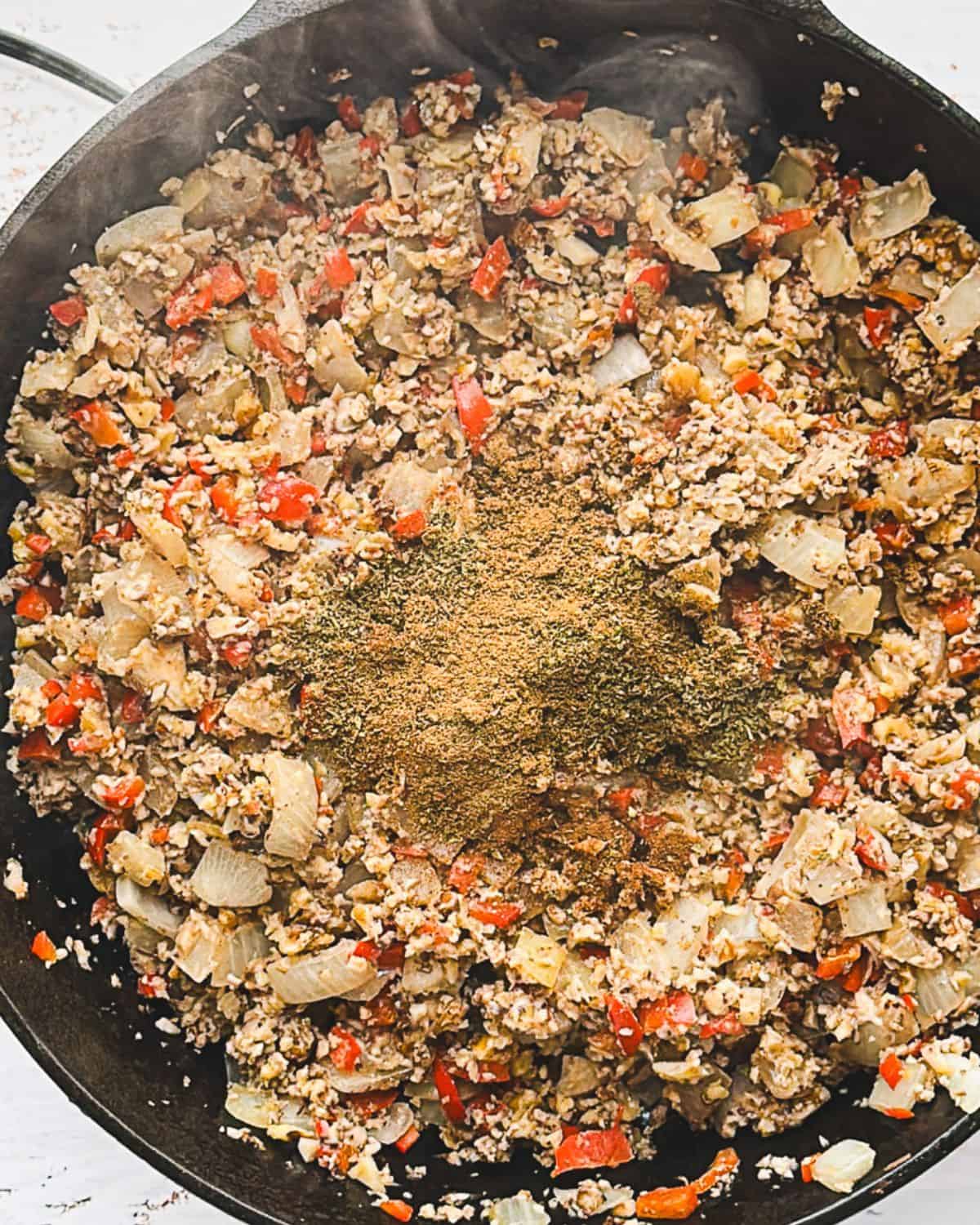 adding spices to vegan picadillo