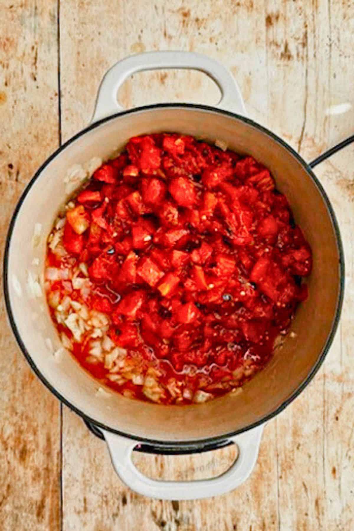 adding tomatoes to vegan tomato soup