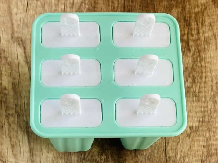 banana mixture in popsicle molds with lids on