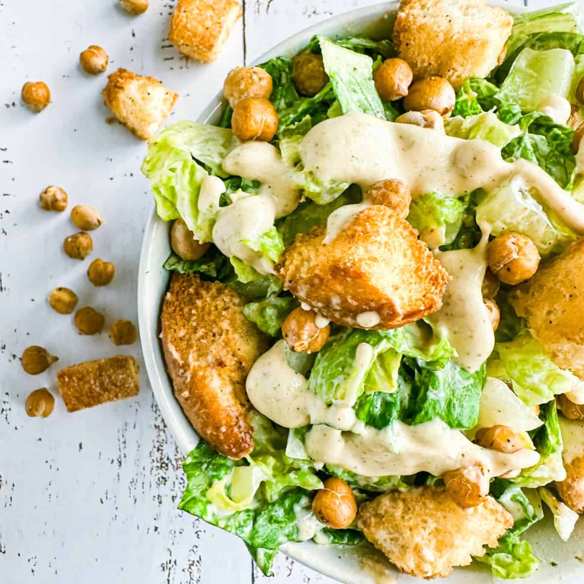 vegan caesar salad in a bowl, top view, only half the dish showing