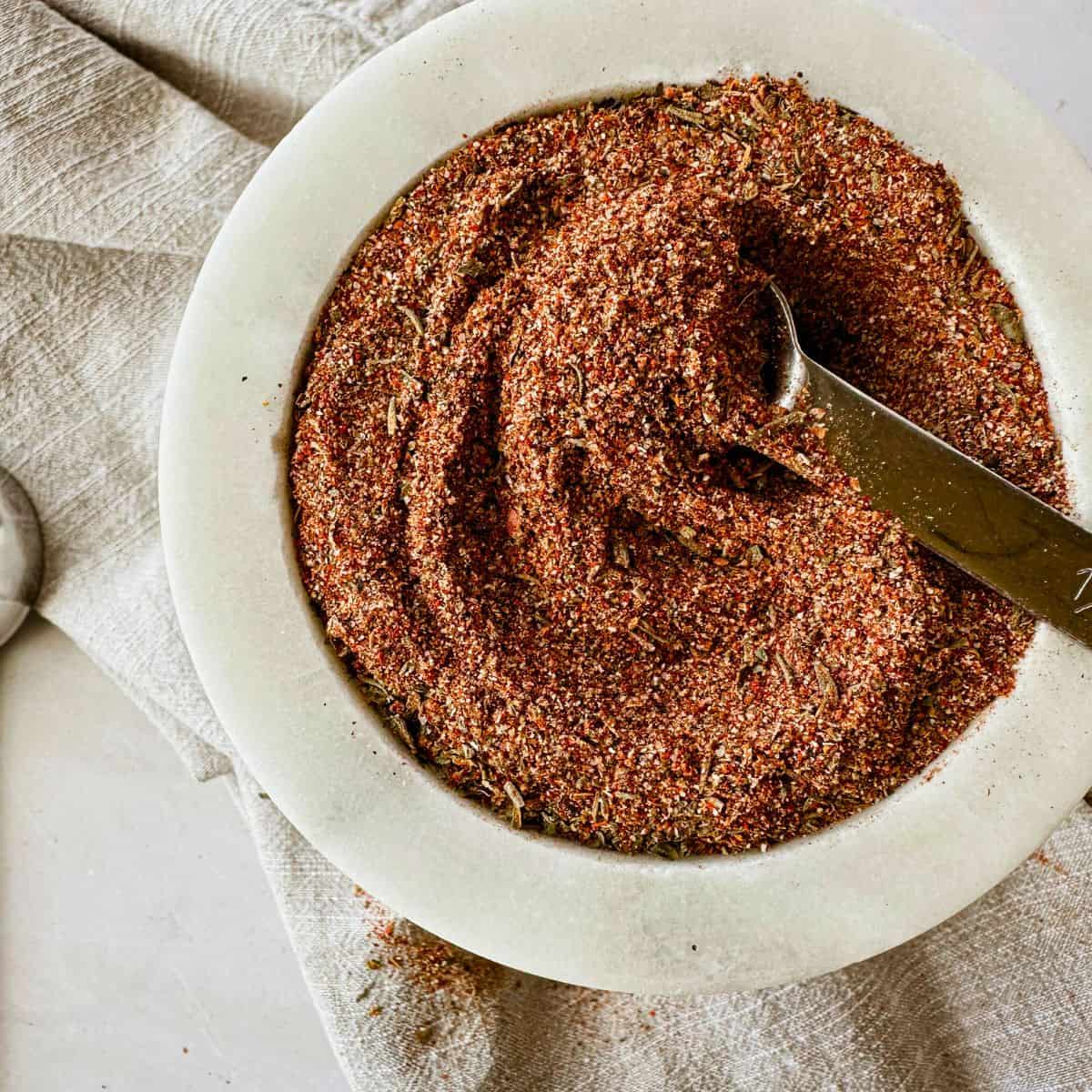 creole seasoning blend top view with measuring spoon in it