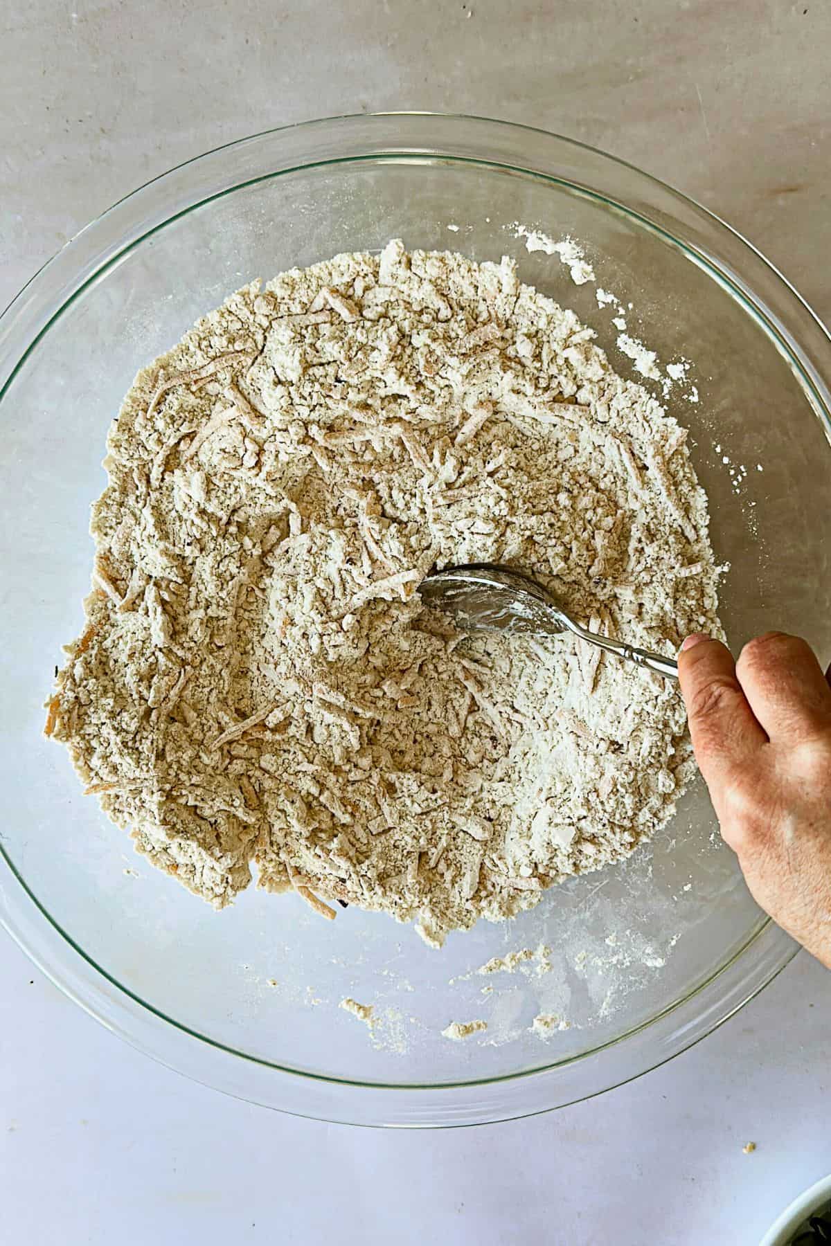 top view of mixing dry ingredients for savory vegan zucchini muffins