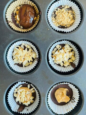 peanut butter, peanuts, and rice puffs filling is added to the pb cups