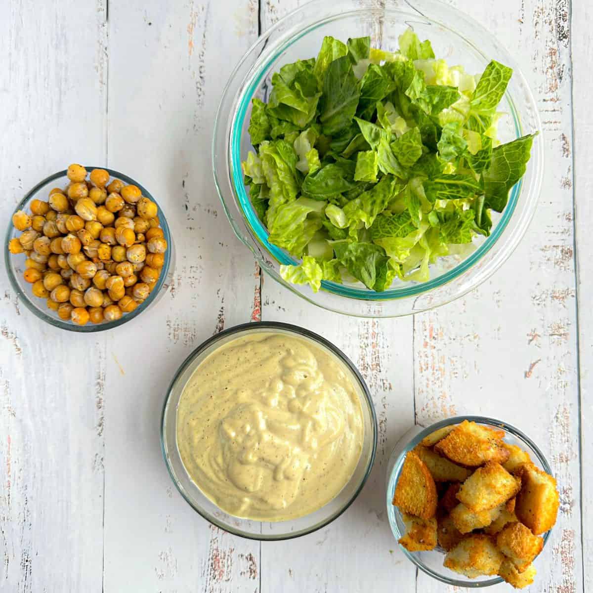 ingredients for caesar salad in bowls