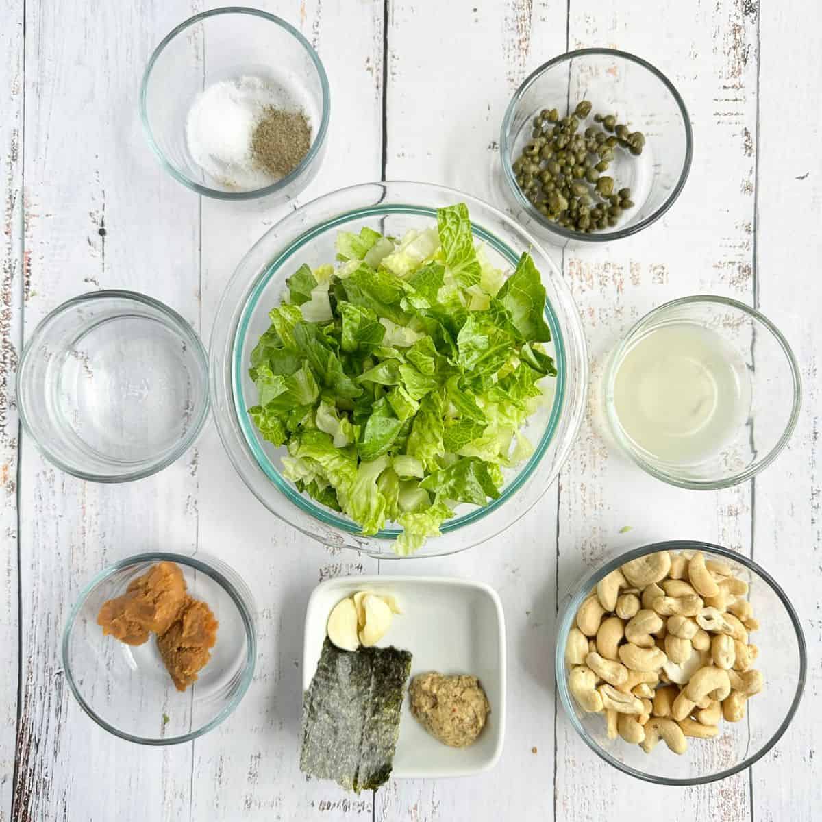 ingredients for vegan caesar dressing in bowls