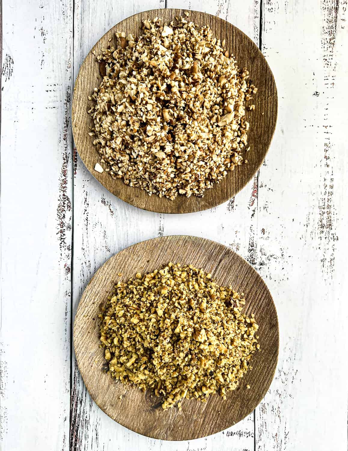 first two ingredients for vegan picadillo - two plates; one with pulsed walnut and one with pulsed mushrooms