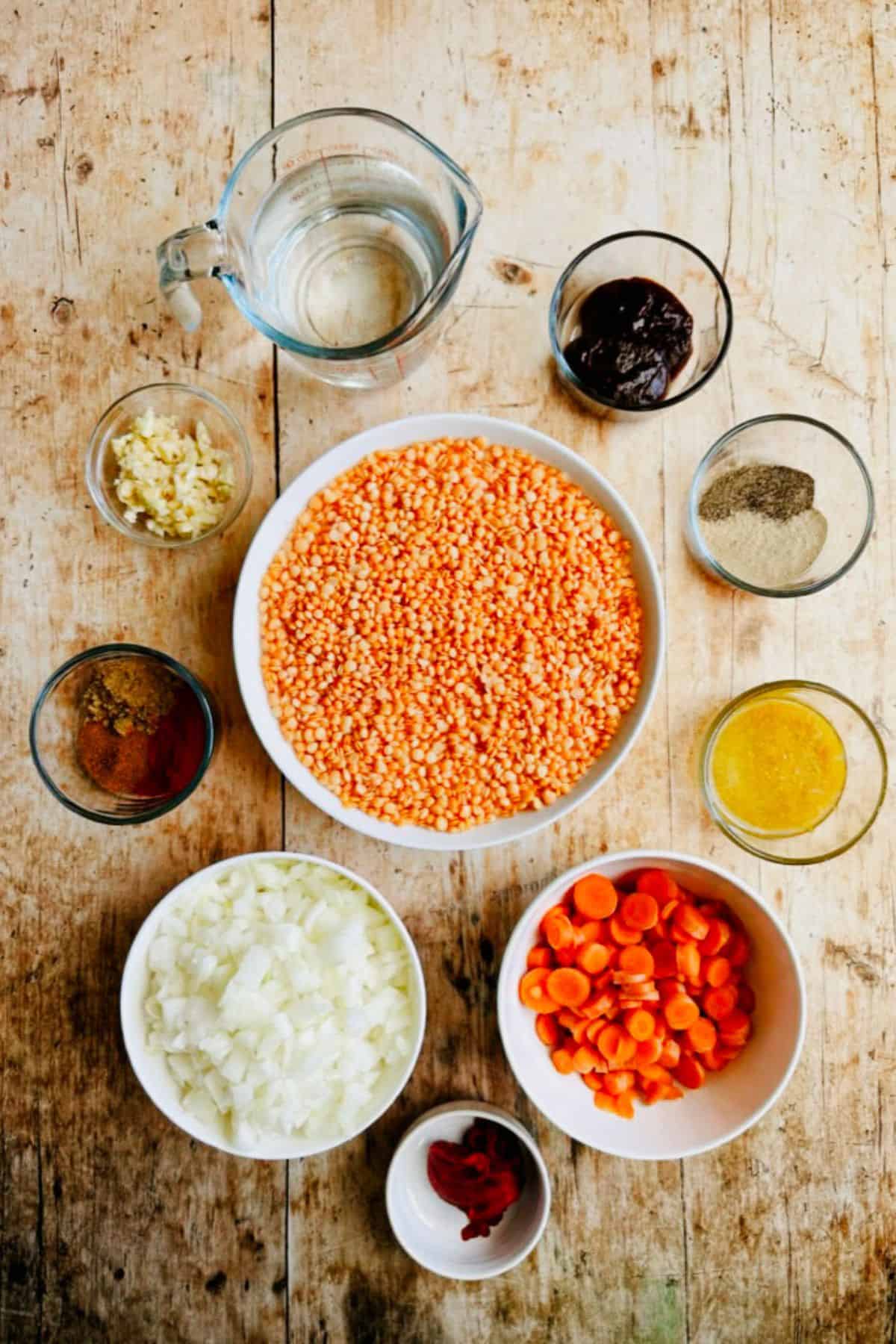 ingredients for healthy red lentil soup in bowls, top view