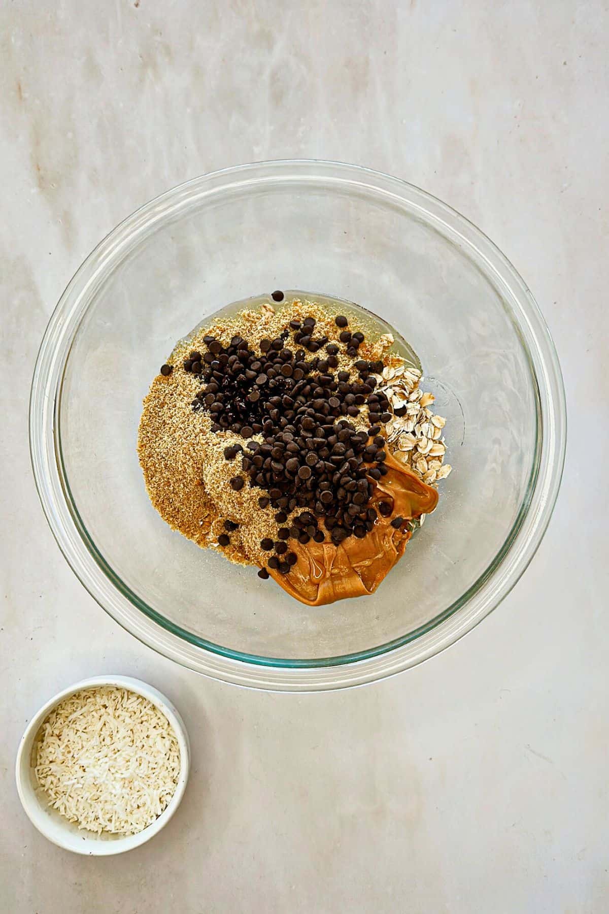 ingredients for vegan chocolate chip energy balls in a bowl