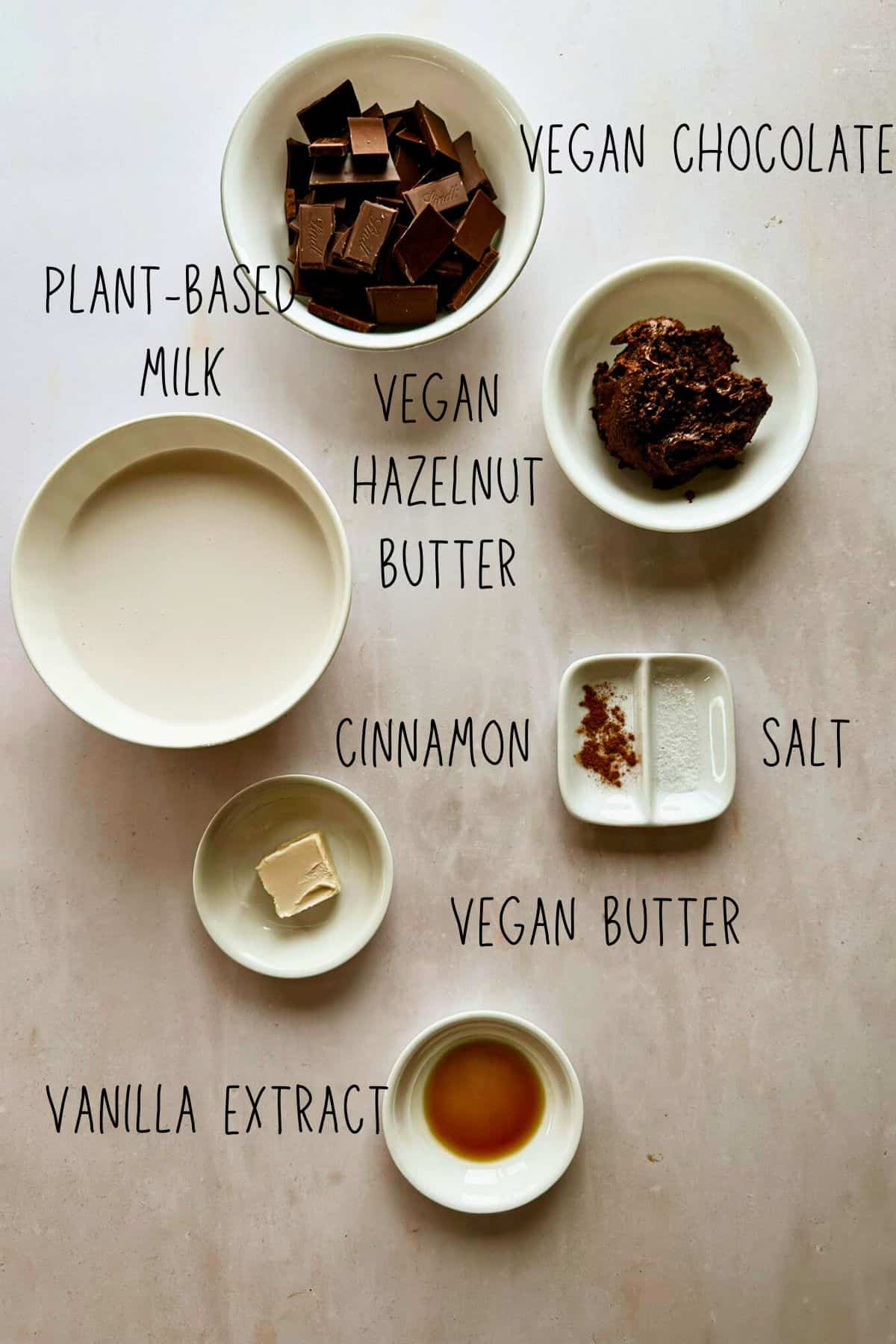 ingredients for vegan chocolate hazelnut fondue in bowls