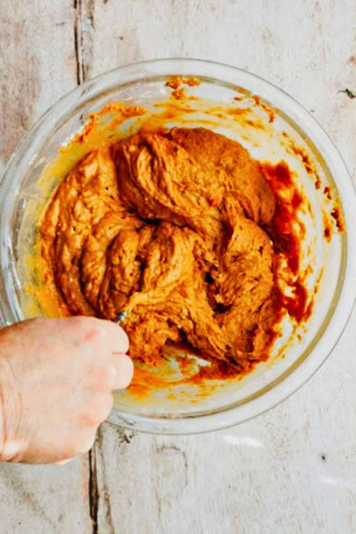 mix pumpkin with spice cake mix powder in a bowl