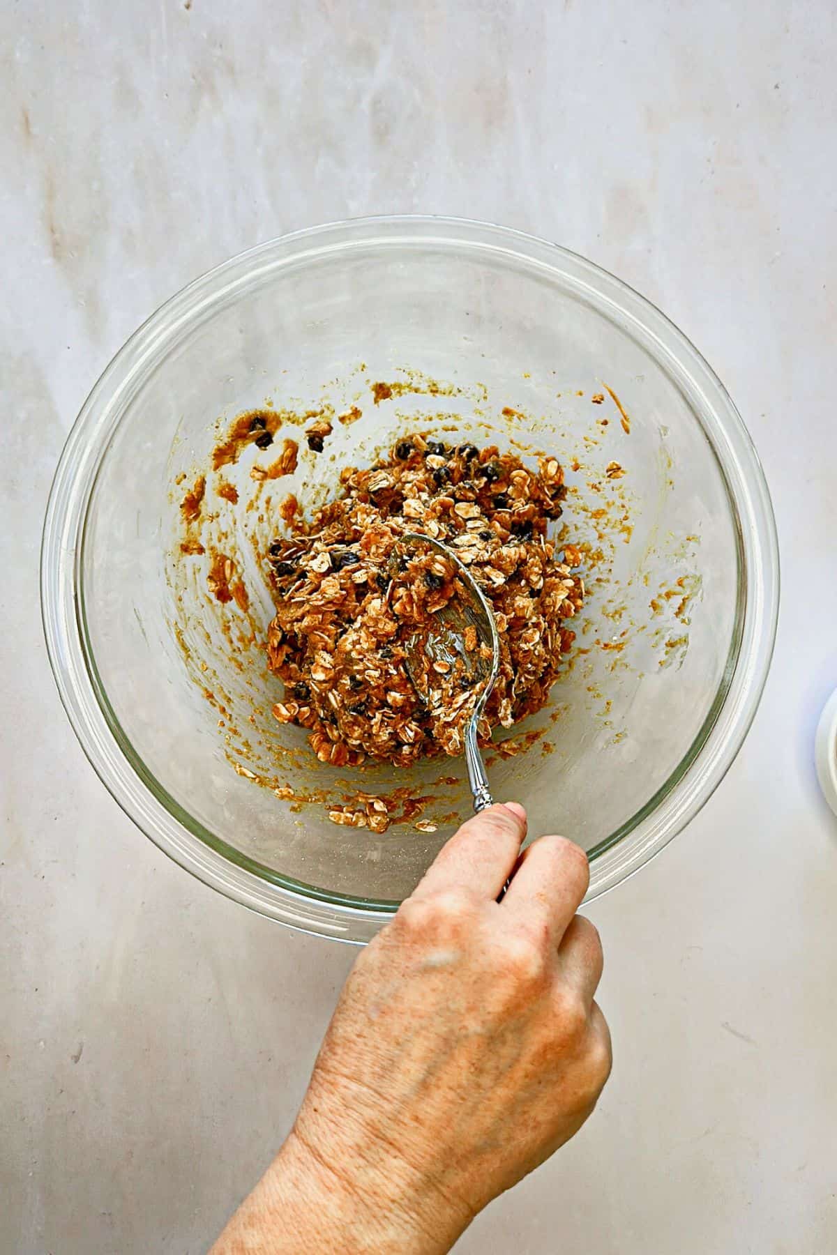 mixing ingredients for vegan chocolate chip energy balls in a bowl