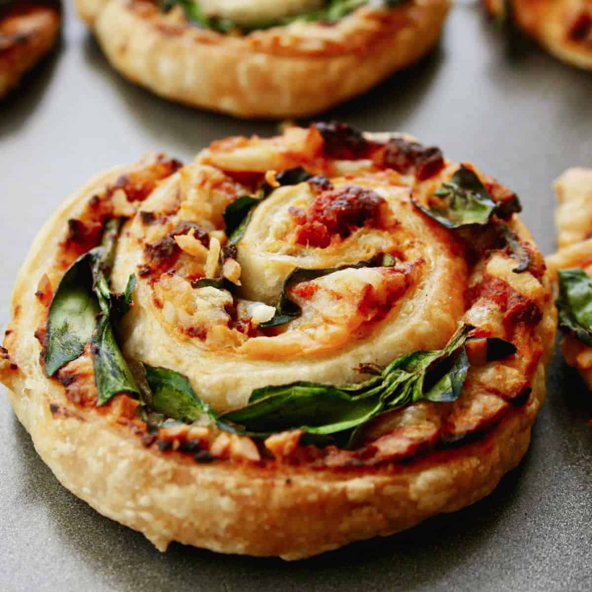 close up of single pizza roll on a baking sheet