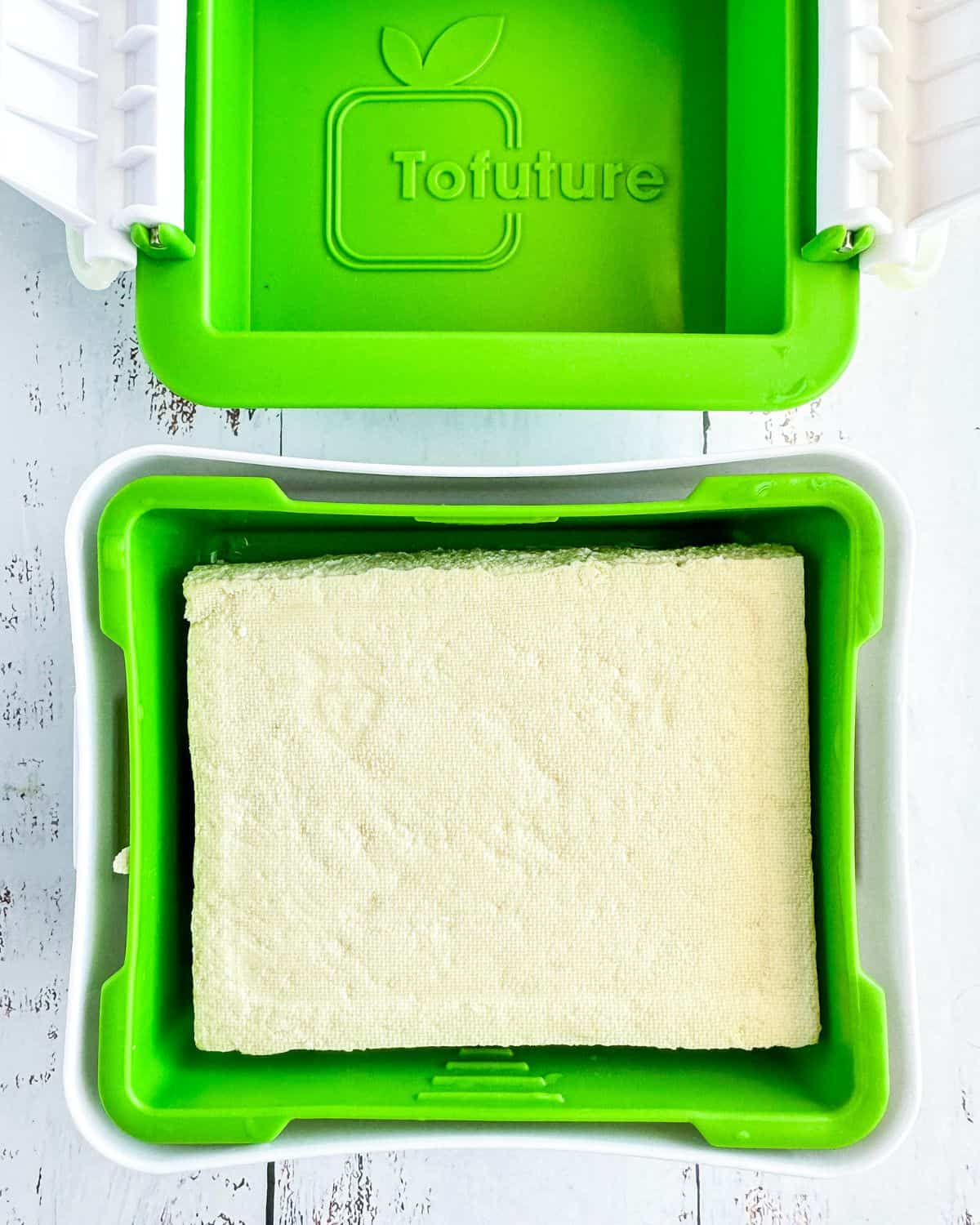 tofu in pressing equipment for removing excess liquid