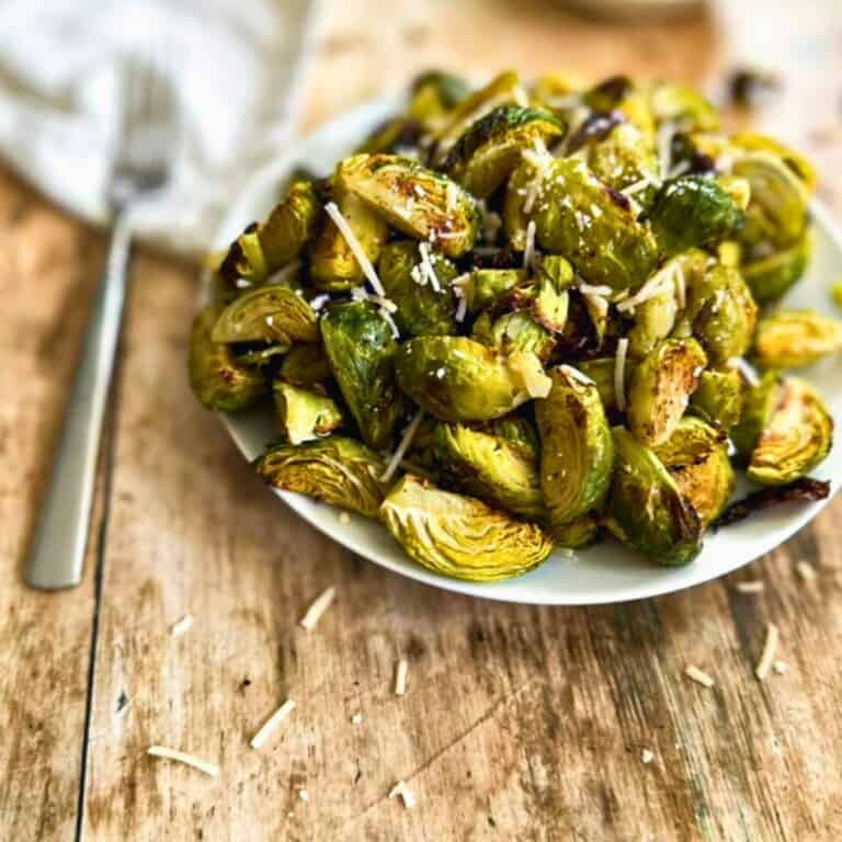 roasted brussels sprouts with vegan parmesan on a plate