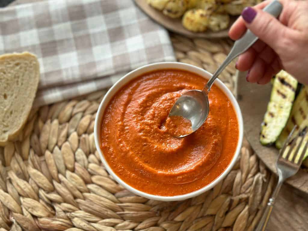 romesco sauce stirred with a spoon