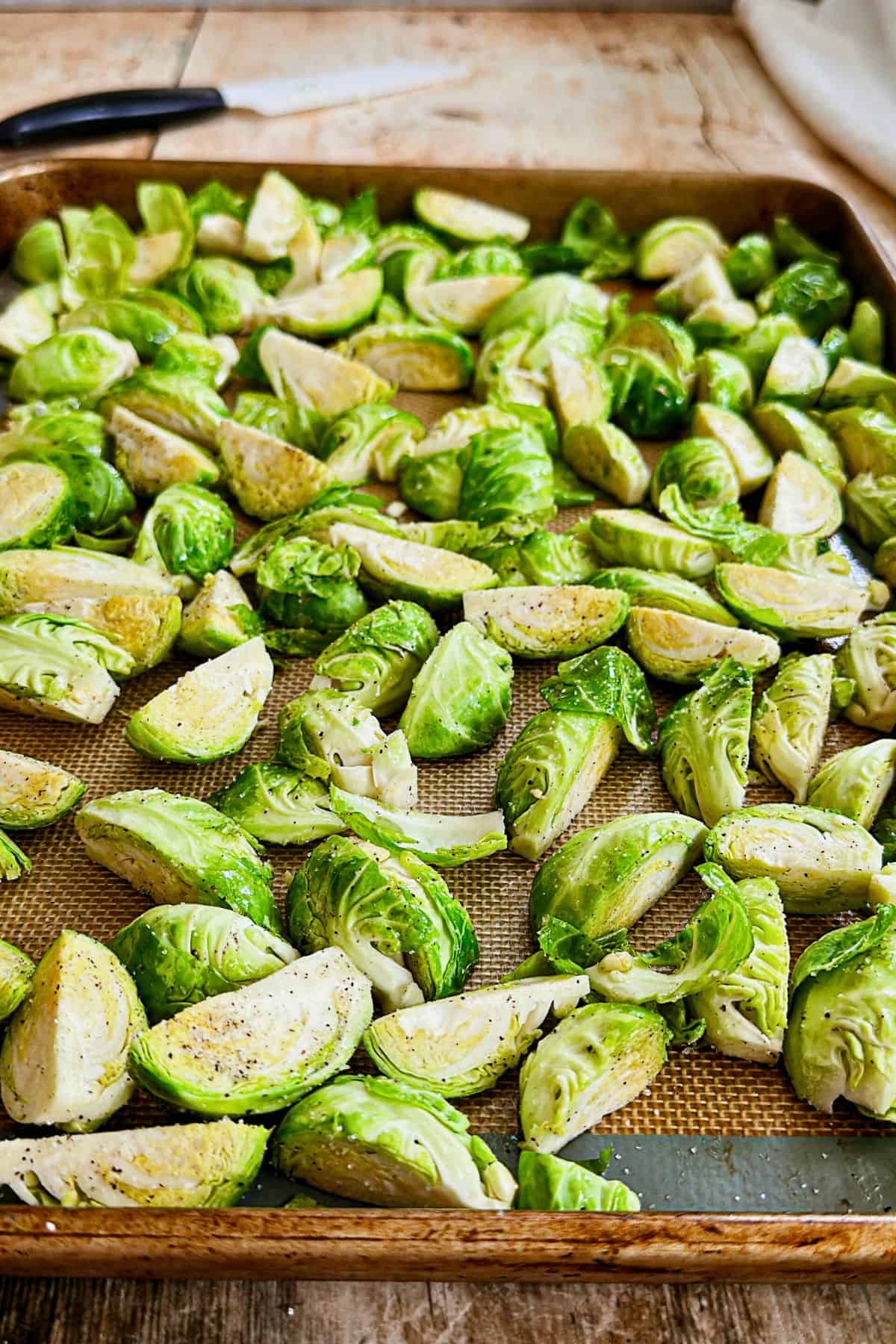 seasoned quartered Brussels sprouts on baking pan
