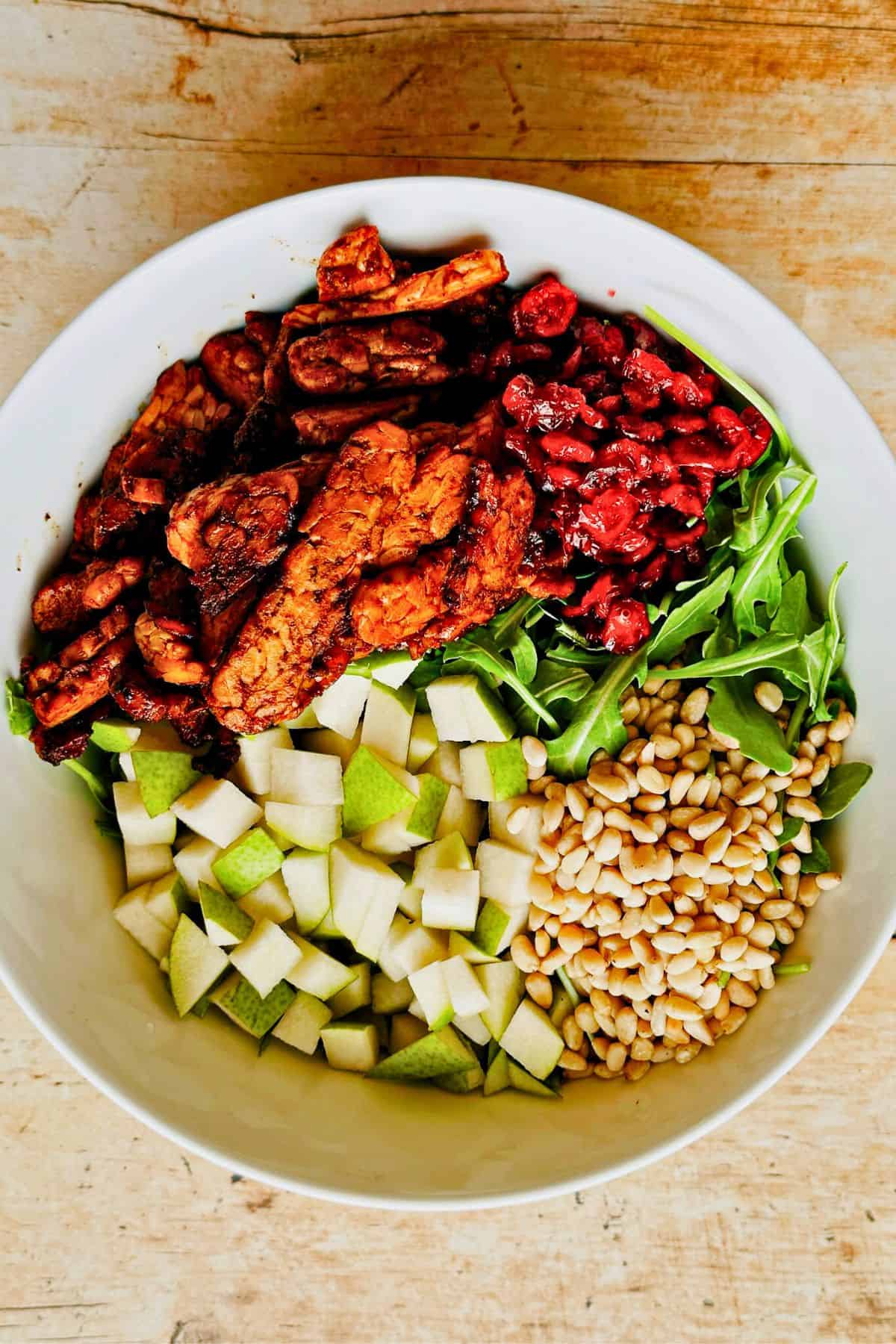 smoky tempeh pears pine nuts cranberries arugula salad