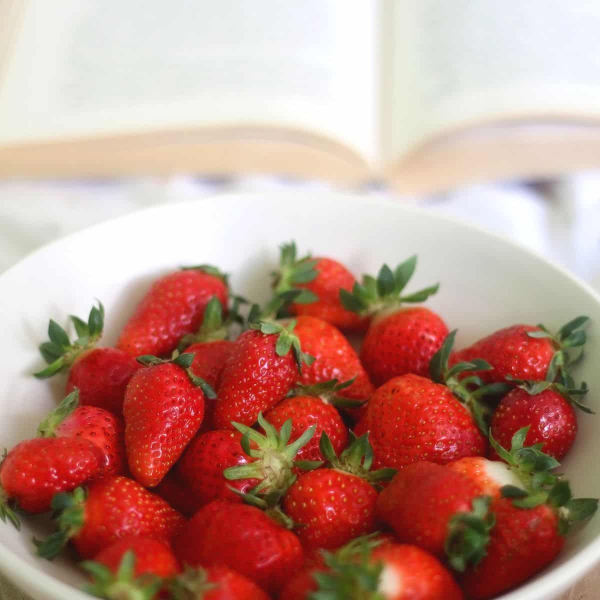 starberries in a bowl with a book open in the back