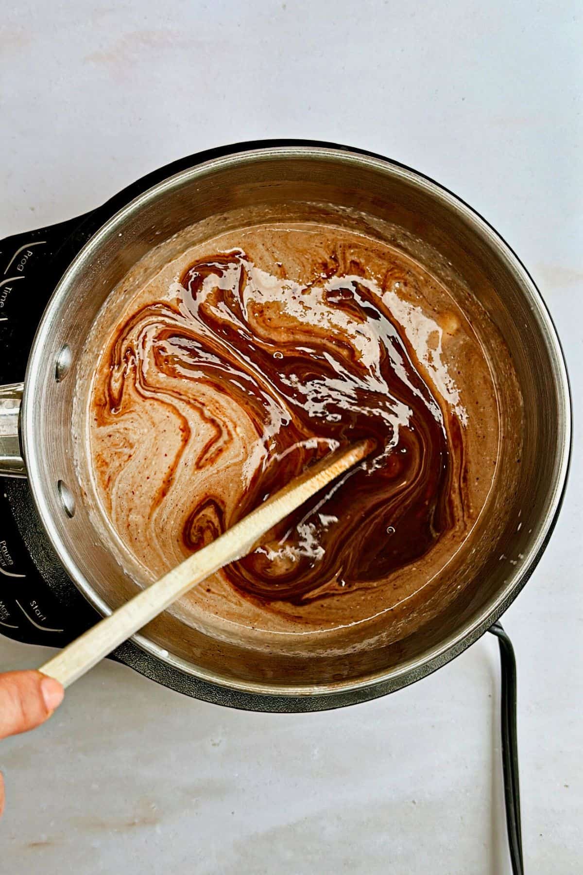 stirring vegan chocolate hazelnut fondue