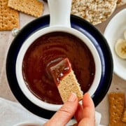 graham cracker dipped into vegan chocolate peanut butter fondue dip; top view