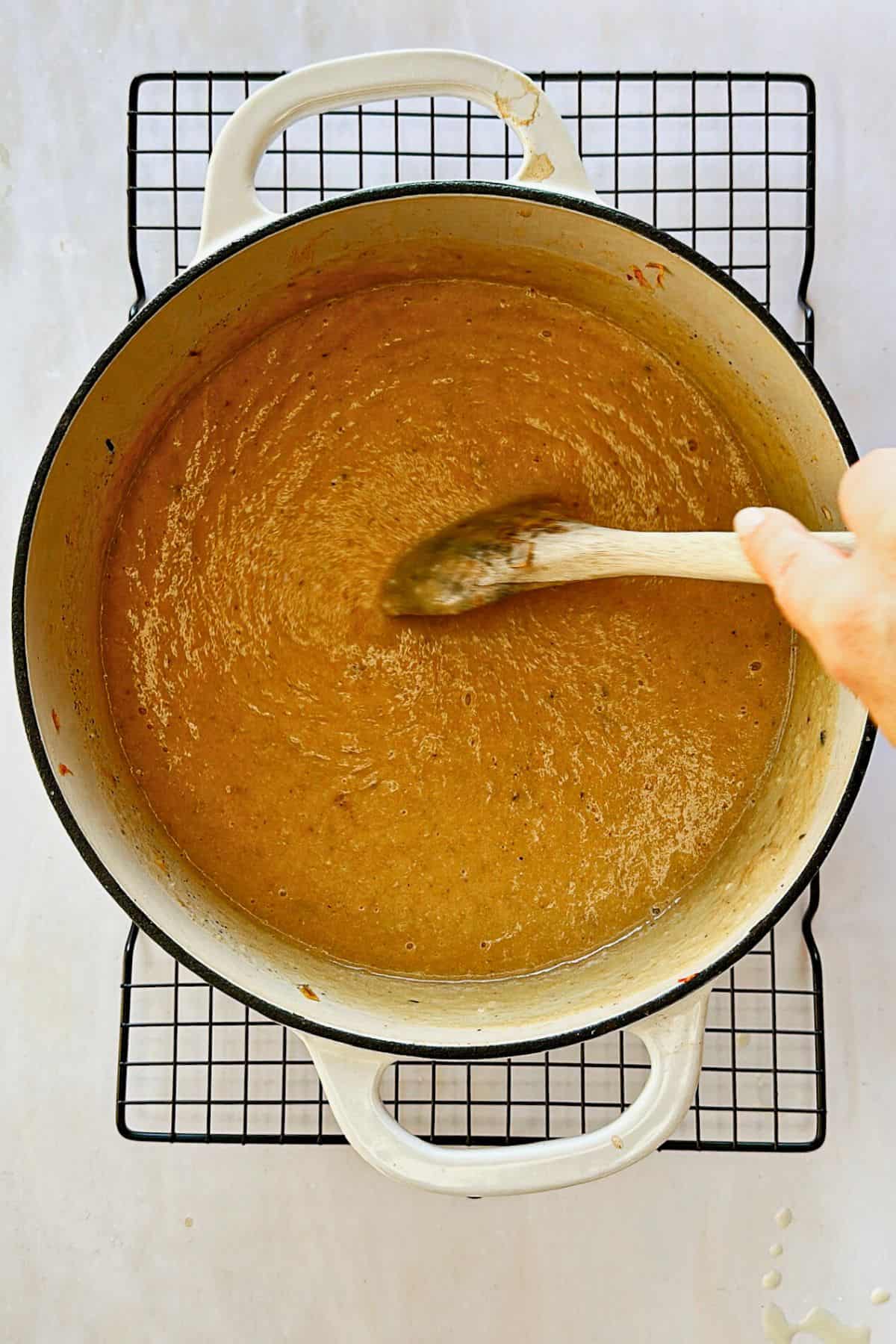 stirring vegan potato and cauliflower soup