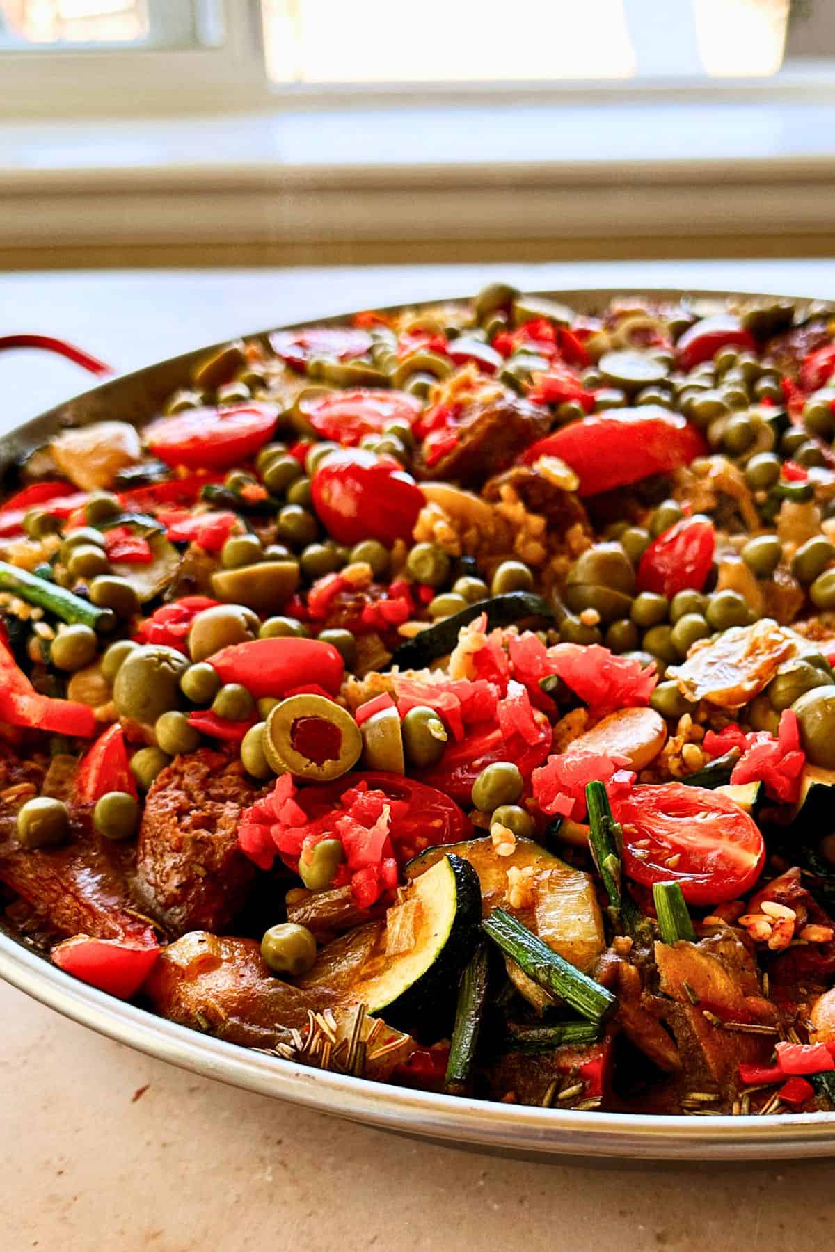 vegan spanish paella in the pan; side view.