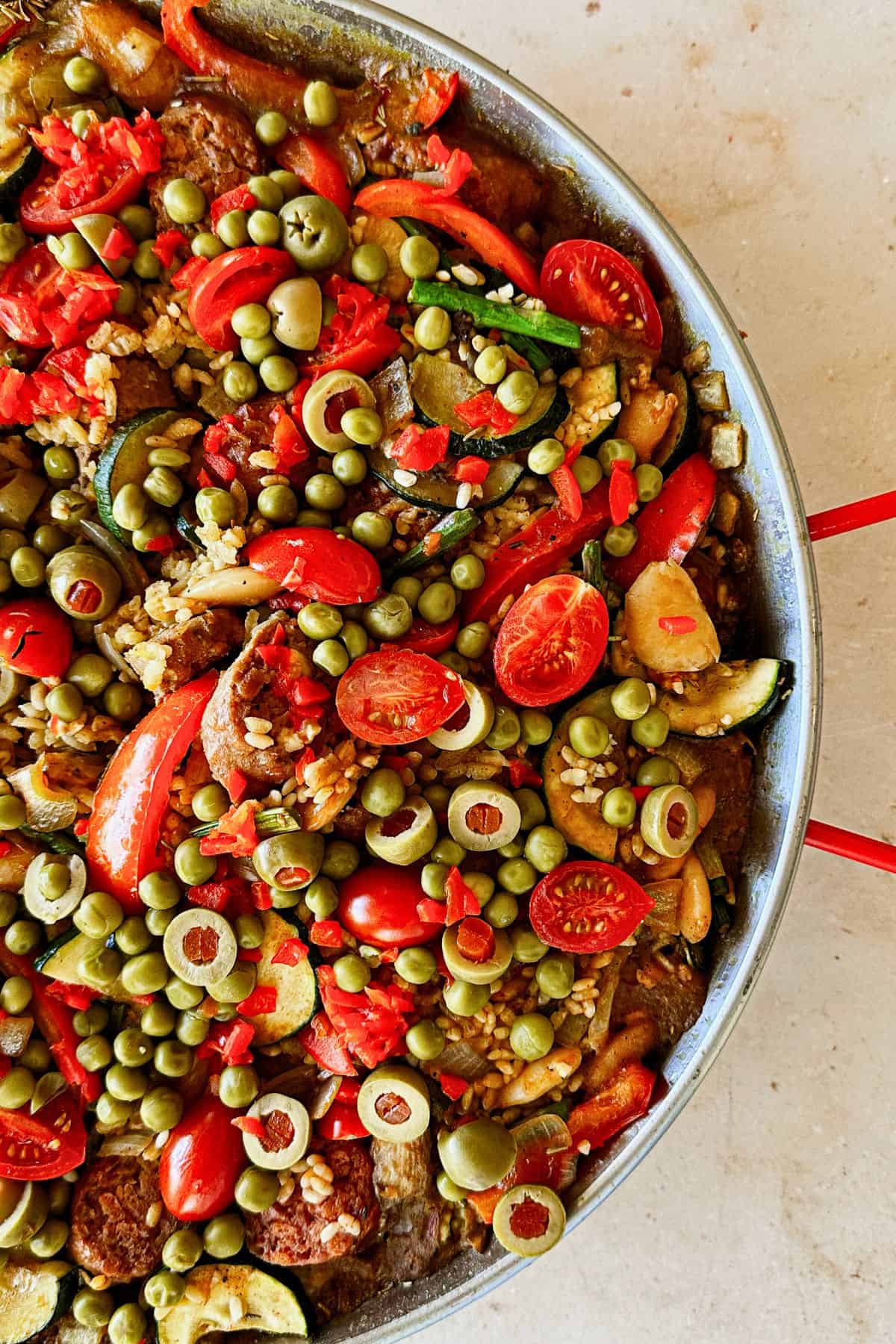 half the pan showing the paella; top view.