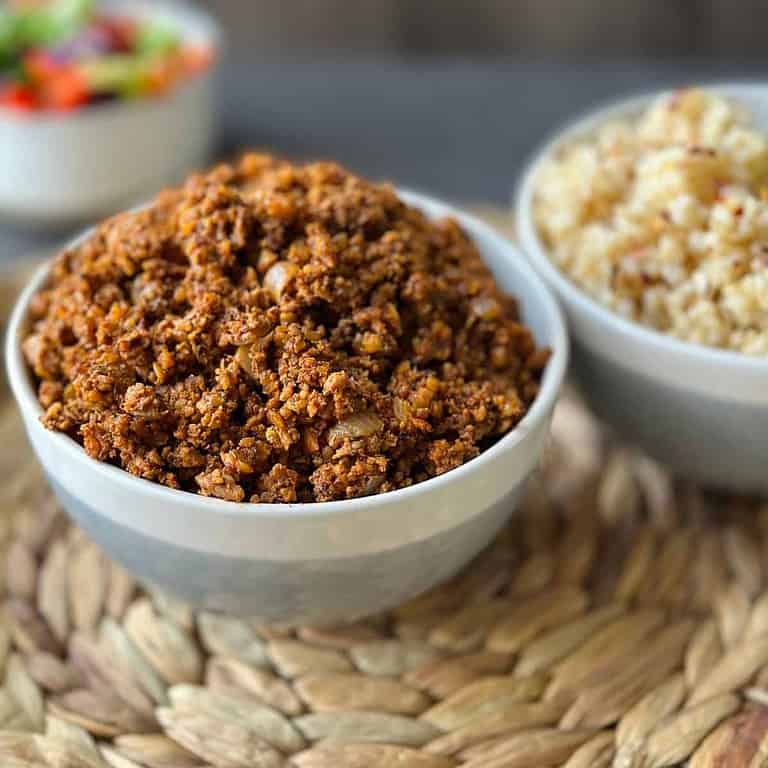 walnut meat in a bowl next to brown rice