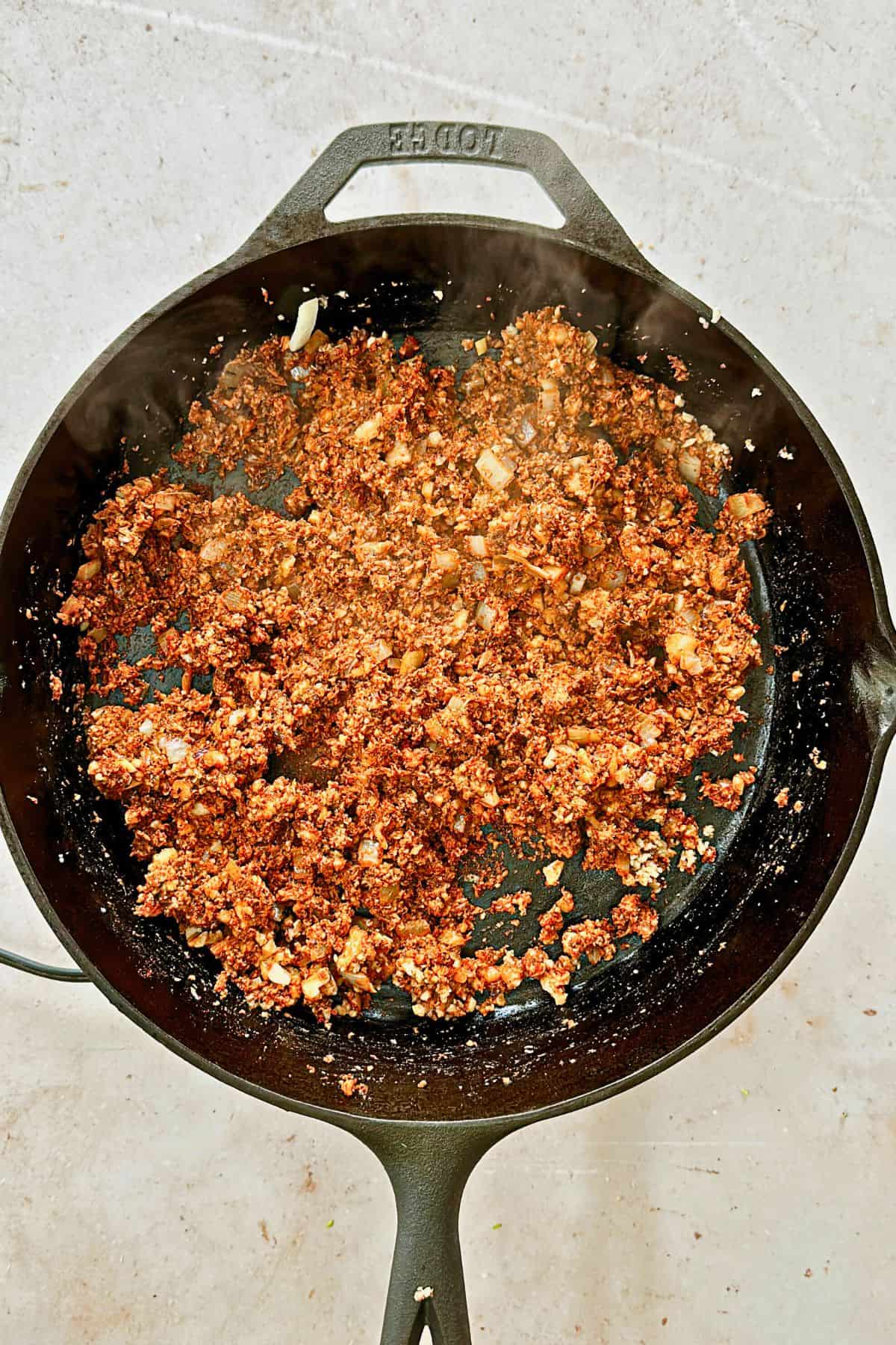 walnut taco meat in a cast iron pan; top view