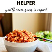 A heaping bowl of saucy vegan hamburger helper macaroni served with a side salad, with text reading 'How to Make Vegan Hamburger Helper you'll never guess is vegan!