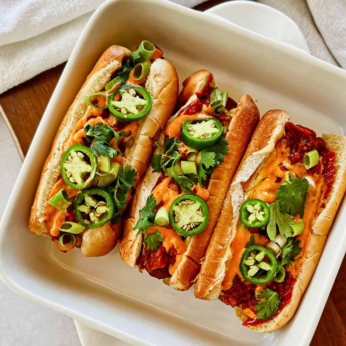 three vegan chili dogs in a casserole.