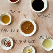 Thai Peanut Sauce ingredients in bowls on a table; overhead shot.