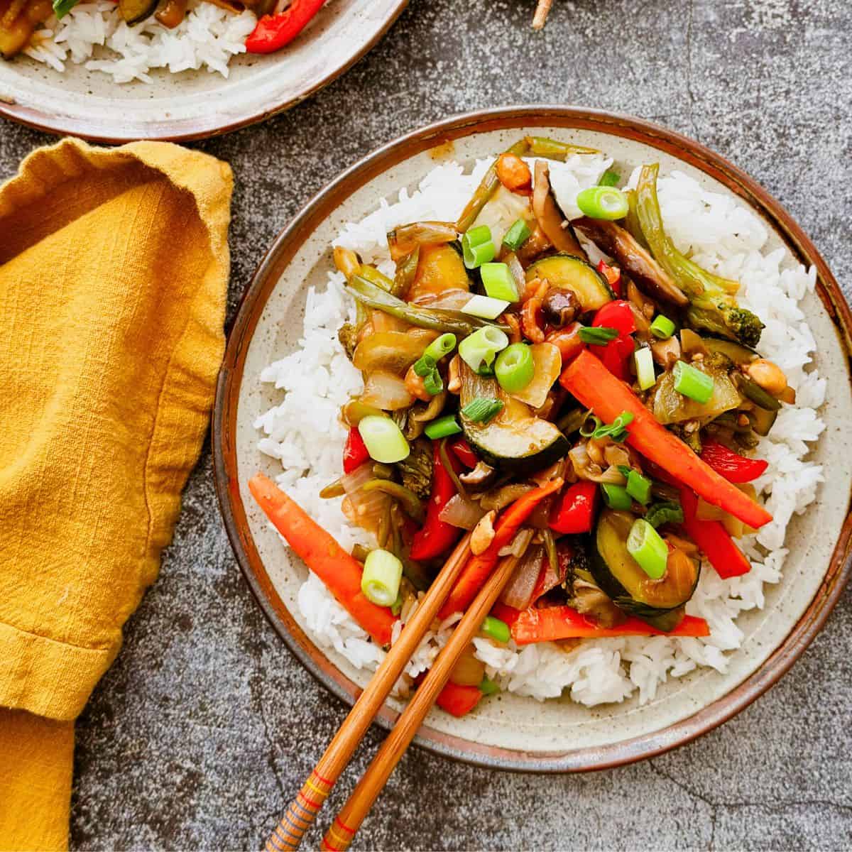 kung pao vegetables on a plate with rice.