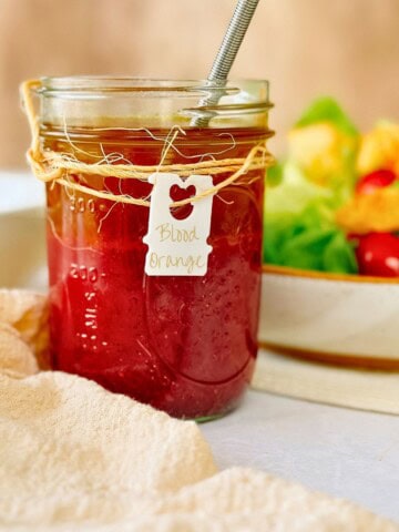 blood orange vinaigrette in a mason jar with a label that says blood orange.