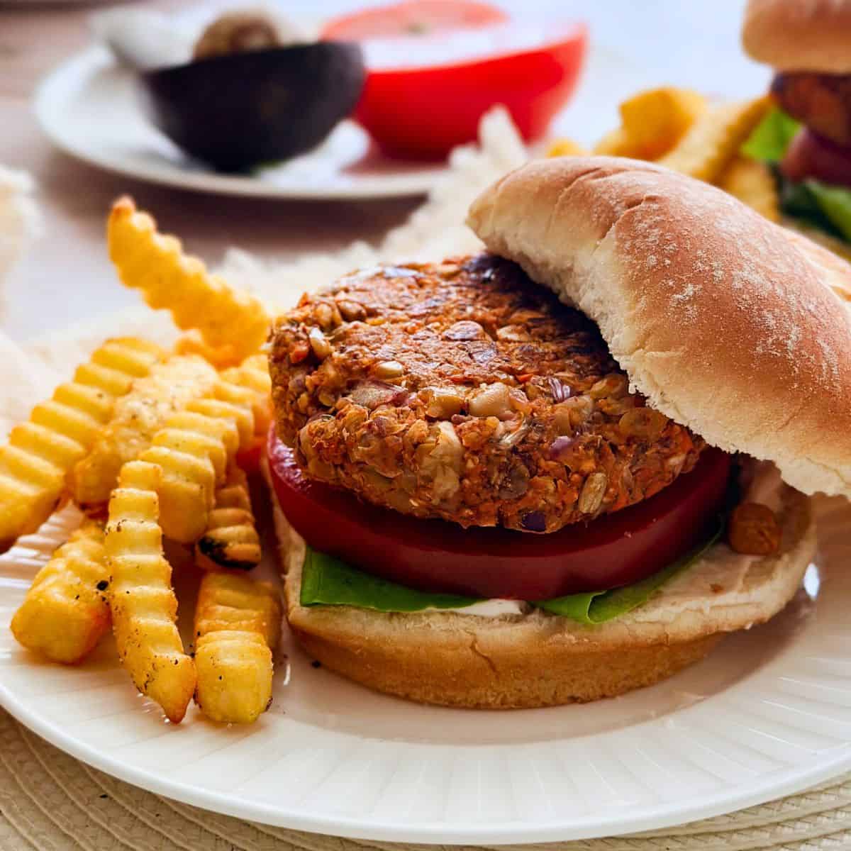 vegan chickpea burger on a plate with fries.