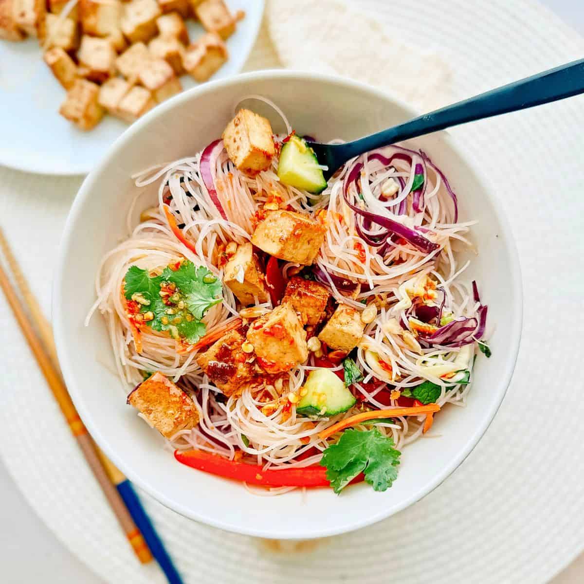 spring roll salad in a bowl with a fork.